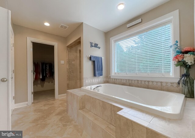 21143 Catnip Ct, Leonardtown, MD 20650 - full bath with a garden tub, a shower stall, a walk in closet, recessed lighting, and baseboards