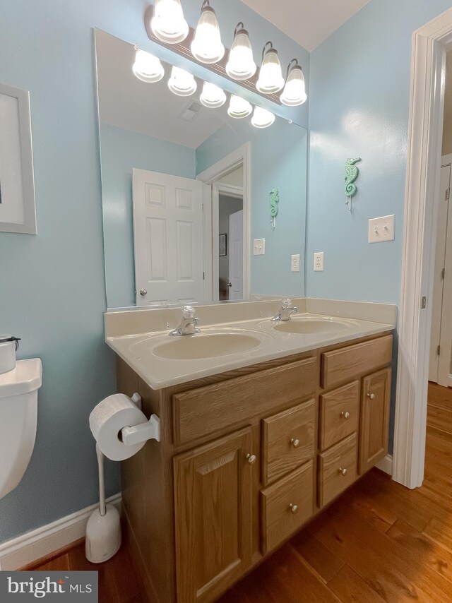 21143 Catnip Ct, Leonardtown, MD 20650 - bathroom featuring toilet, wood finished floors, and double vanity