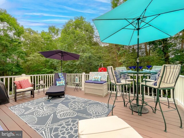 21143 Catnip Ct, Leonardtown, MD 20650 - wooden terrace with outdoor dining area and view of wooded area