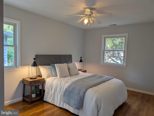 9510 Clement Rd, Silver Spring, MD 20910 - bedroom featuring multiple windows, baseboards, and wood finished floors