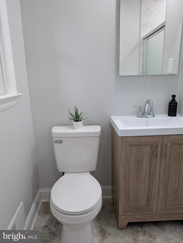 9510 Clement Rd, Silver Spring, MD 20910 - bathroom with toilet, baseboards, and vanity