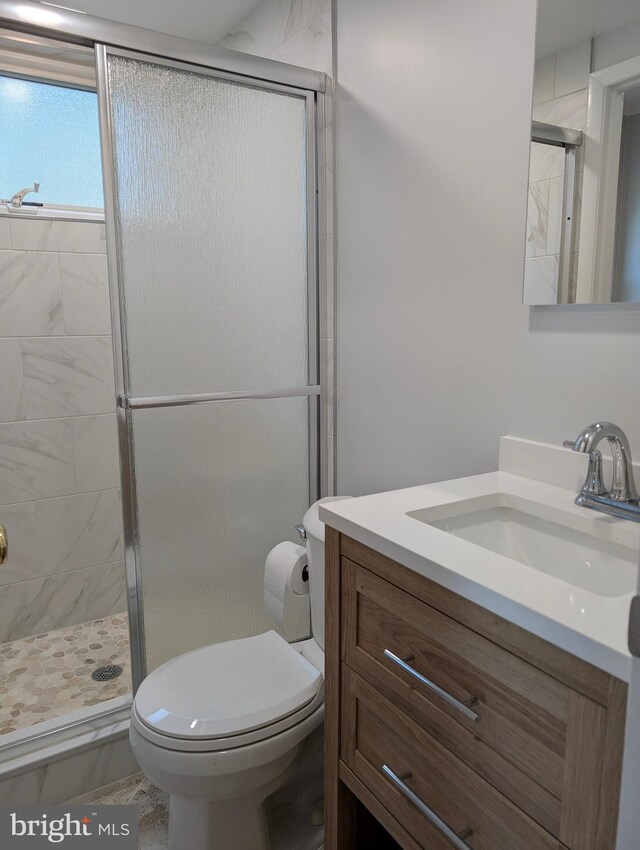 9510 Clement Rd, Silver Spring, MD 20910 - bathroom with vanity, a stall shower, and toilet