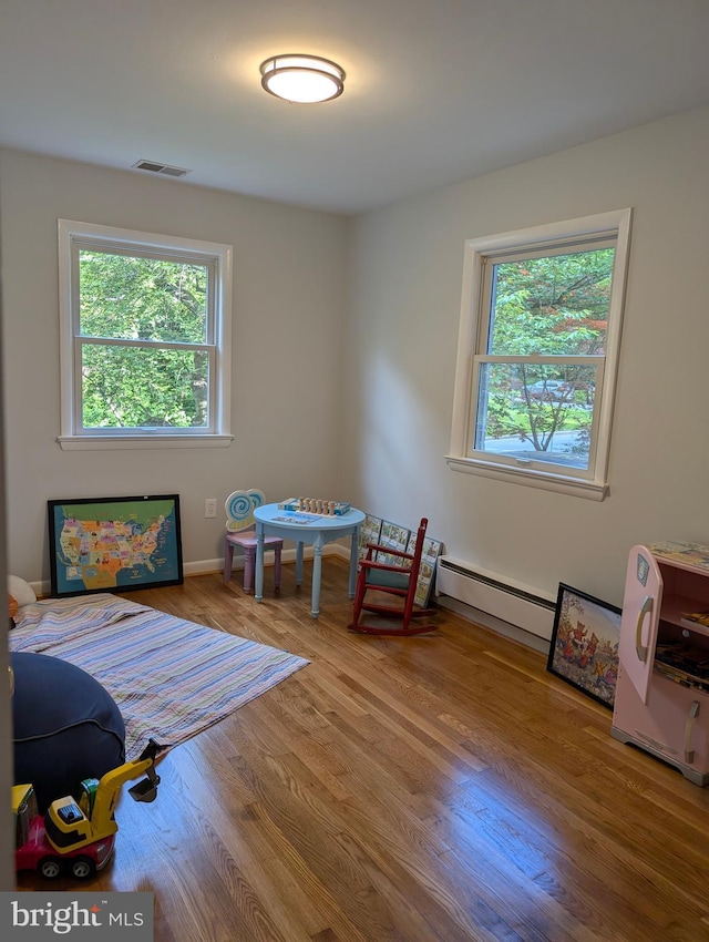 9510 Clement Rd, Silver Spring, MD 20910 - bedroom with a baseboard heating unit and wood finished floors