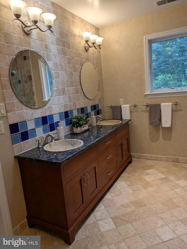 9510 Clement Rd, Silver Spring, MD 20910 - full bathroom with a chandelier, double vanity, baseboards, and decorative backsplash