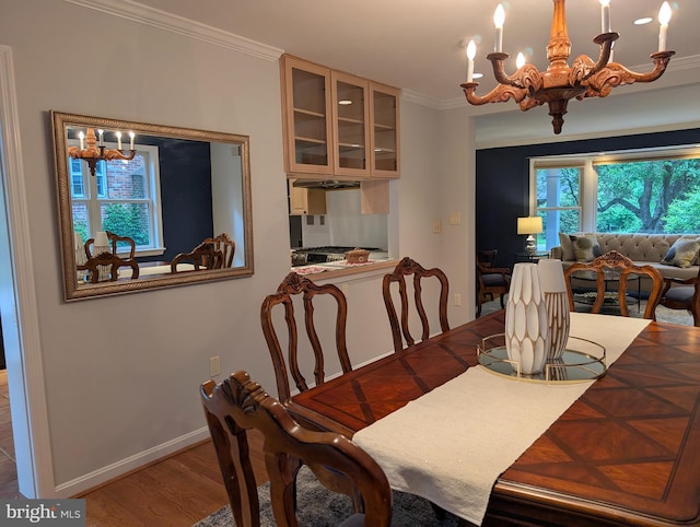 9510 Clement Rd, Silver Spring, MD 20910 - dining area with a chandelier, crown molding, wood finished floors, and baseboards