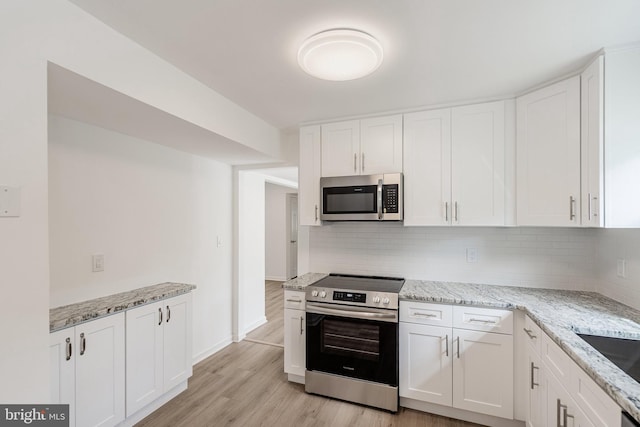 11 Rivercrest, Little Egg Harbor Twp, NJ 08087 - kitchen featuring stainless steel appliances, white cabinets, backsplash, and light wood-style flooring