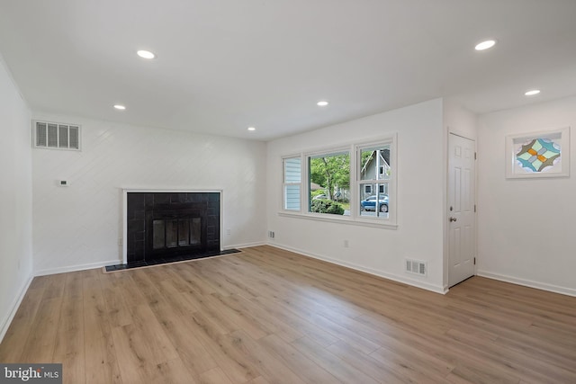 11 Rivercrest, Little Egg Harbor Twp, NJ 08087 - unfurnished living room with baseboards, light wood-style floors, recessed lighting, and a fireplace with flush hearth