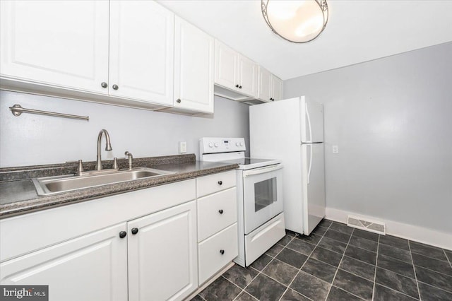 15 Degrange St, Frederick, MD 21701 - kitchen featuring white appliances, a sink, dark countertops, white cabinets, and baseboards
