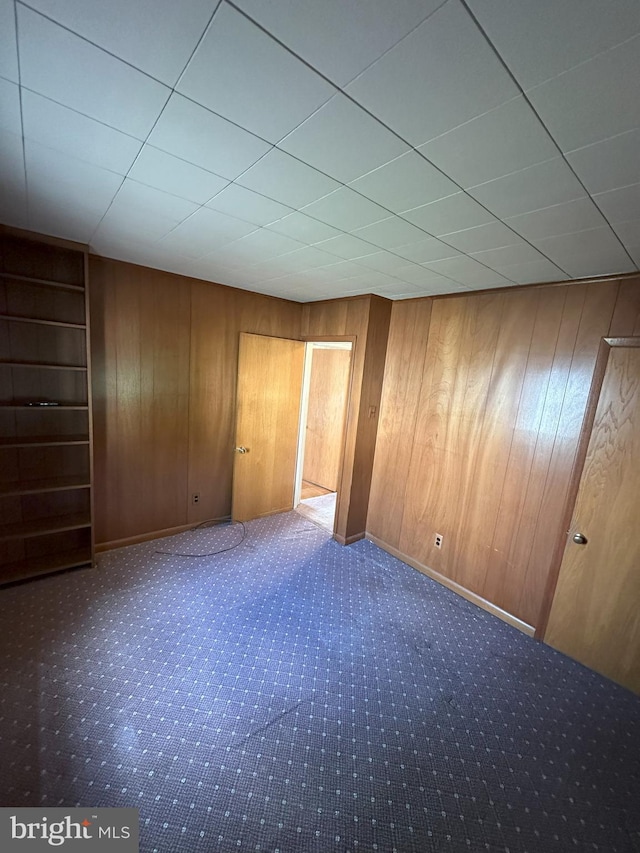 120 Lindsey Ave, Runnemede, NJ 08078 - unfurnished bedroom featuring wood walls, carpet flooring, and a paneled ceiling