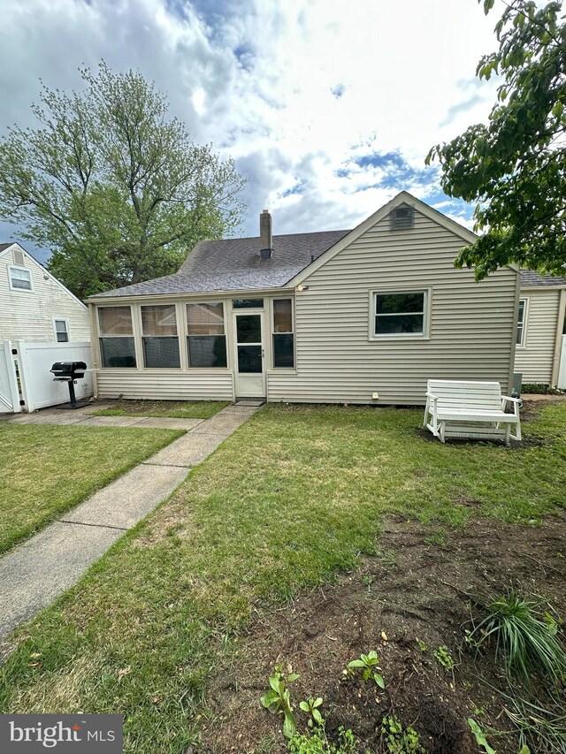120 Lindsey Ave, Runnemede, NJ 08078 - rear view of property featuring a shingled roof, a chimney, and a sunroom