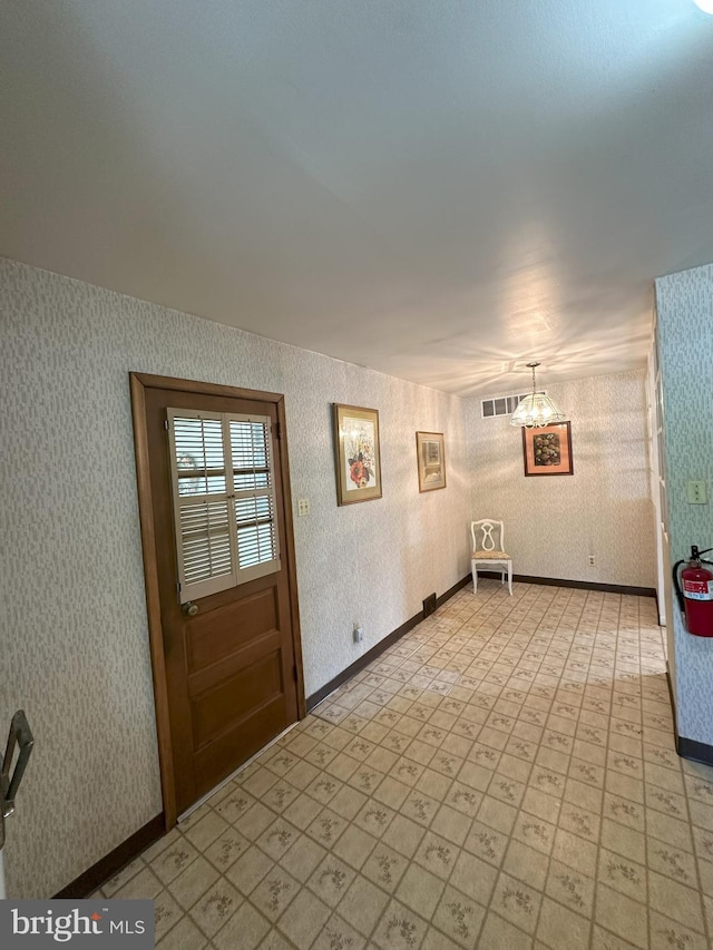 120 Lindsey Ave, Runnemede, NJ 08078 - foyer entrance with wallpapered walls, a chandelier, light flooring, and baseboards