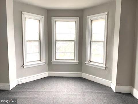 1364 Park Blvd, Camden, NJ 08103 - empty room featuring dark colored carpet and baseboards