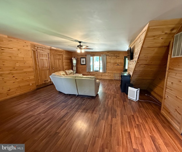 1243 Garry Ave, Vineland, NJ 08361 - living room with dark wood-style floors, wooden walls, and ceiling fan