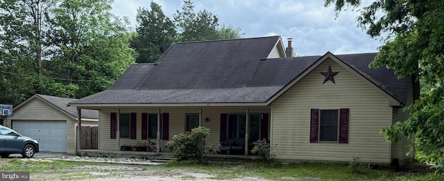 1243 Garry Ave, Vineland, NJ 08361 - view of front of property with a porch, a detached garage, an outdoor structure, a shingled roof, and driveway