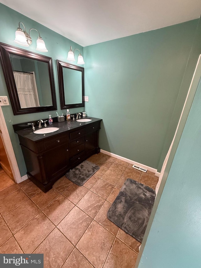 1243 Garry Ave, Vineland, NJ 08361 - bathroom featuring tile patterned floors, double vanity, and baseboards