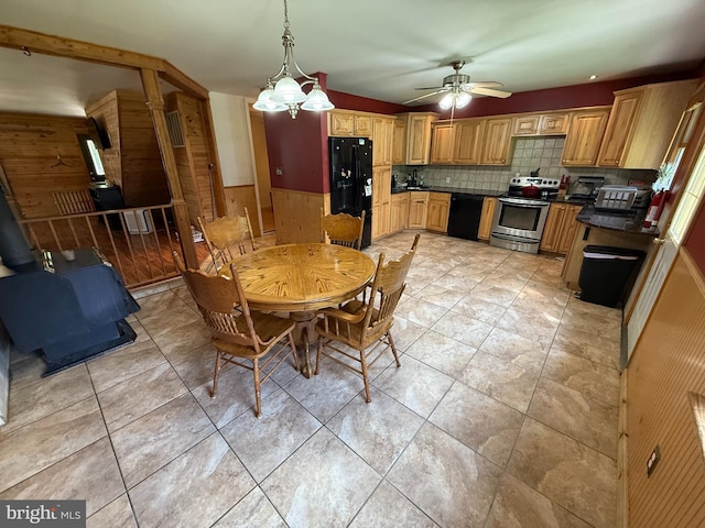 1243 Garry Ave, Vineland, NJ 08361 - dining area with wooden walls, ceiling fan, a wood stove, a wainscoted wall, and light tile patterned floors