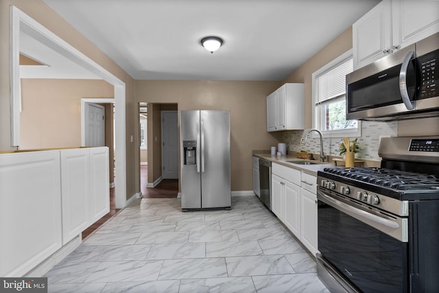 5421 Omaha Ave, Baltimore, MD 21206 - kitchen with appliances with stainless steel finishes, a sink, light marble finish flooring, and white cabinets