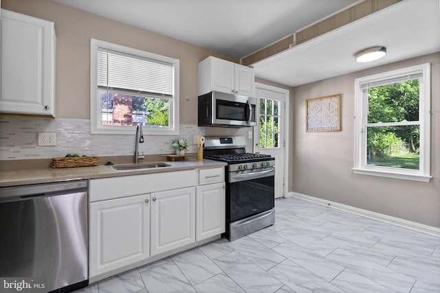 5421 Omaha Ave, Baltimore, MD 21206 - kitchen with stainless steel appliances, a sink, light marble finish flooring, and decorative backsplash