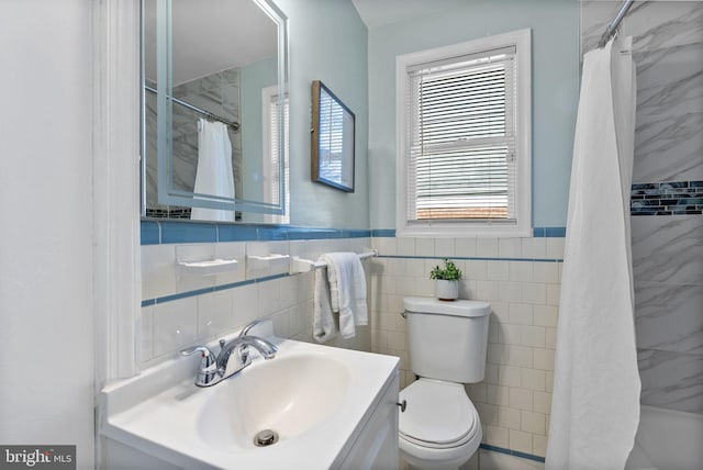 5421 Omaha Ave, Baltimore, MD 21206 - bathroom featuring toilet, tile walls, curtained shower, vanity, and a wainscoted wall