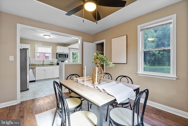 5421 Omaha Ave, Baltimore, MD 21206 - dining area with baseboards, ceiling fan, and light wood-style flooring