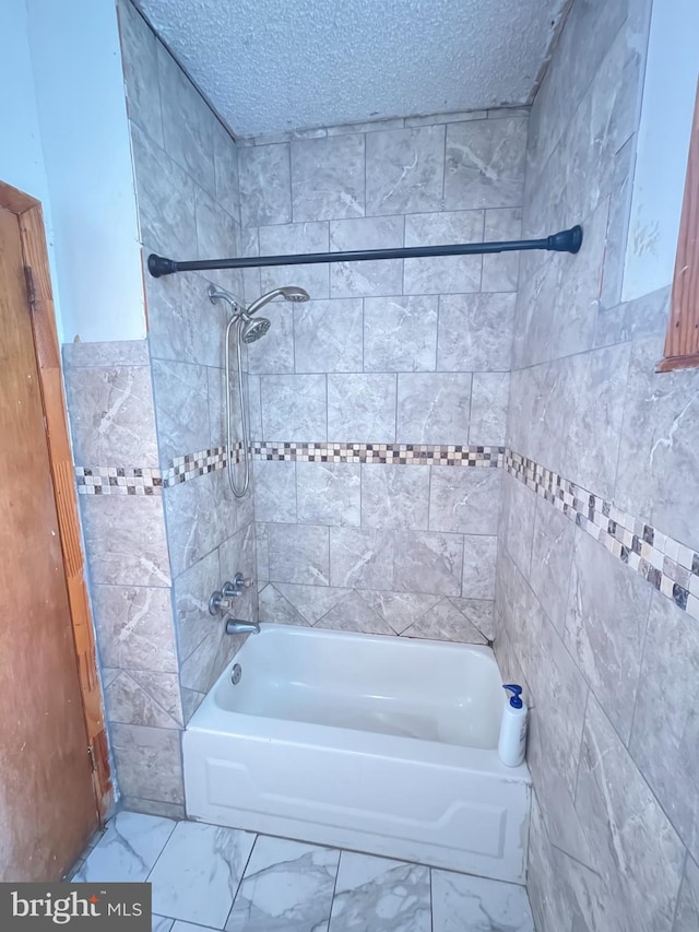 3639 N Darien St, Philadelphia, PA 19140 - full bathroom with shower / tub combination, marble look tile flooring, tile walls, and a textured ceiling