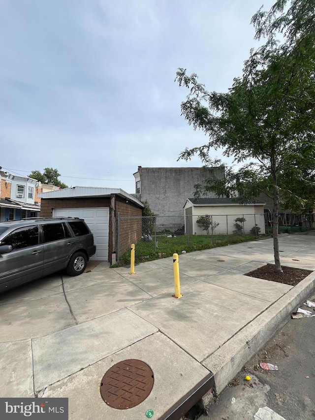 3639 N Darien St, Philadelphia, PA 19140 - view of front of home featuring brick siding, a garage, and an outbuilding