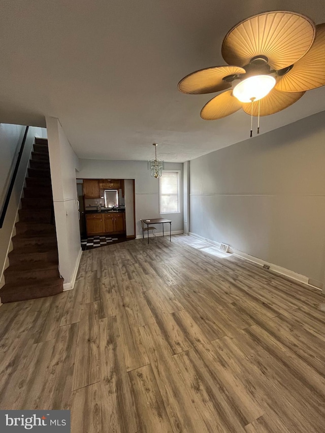 3639 N Darien St, Philadelphia, PA 19140 - unfurnished living room featuring dark wood-type flooring, baseboards, and stairs