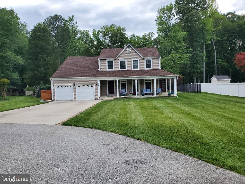 2904 Eutaw Forest Dr, Waldorf, MD 20603 - view of front of home featuring a porch, a garage, driveway, and roof with shingles