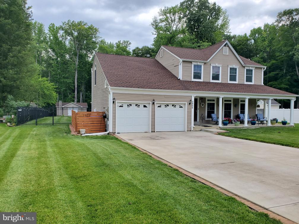 2904 Eutaw Forest Dr, Waldorf, MD 20603 - view of front facade with covered porch, a garage, concrete driveway, and roof with shingles