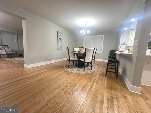 3701 Lochearn Dr, Gwynn Oak, MD 21207 - dining area with light wood-style flooring, a chandelier, and baseboards