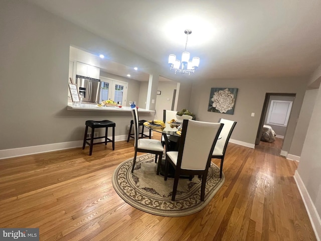 3701 Lochearn Dr, Gwynn Oak, MD 21207 - dining room featuring light wood-type flooring, a chandelier, and baseboards