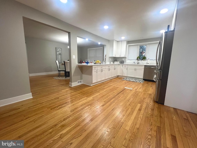 3701 Lochearn Dr, Gwynn Oak, MD 21207 - kitchen with appliances with stainless steel finishes, light wood-type flooring, white cabinetry, light countertops, and a sink