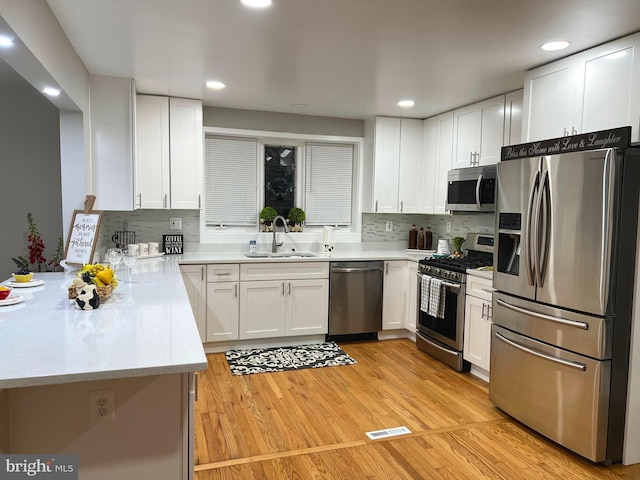 3701 Lochearn Dr, Gwynn Oak, MD 21207 - kitchen featuring stainless steel appliances, a sink, white cabinetry, and recessed lighting