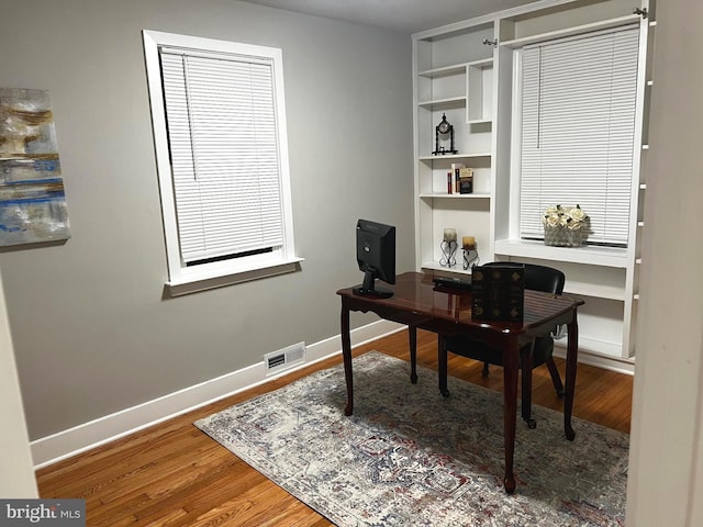 3701 Lochearn Dr, Gwynn Oak, MD 21207 - home office featuring wood finished floors, baseboards, and built in shelves