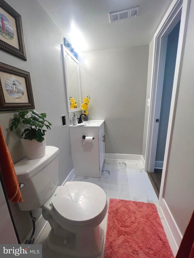 3701 Lochearn Dr, Gwynn Oak, MD 21207 - bathroom with marble finish flooring, vanity, toilet, and baseboards