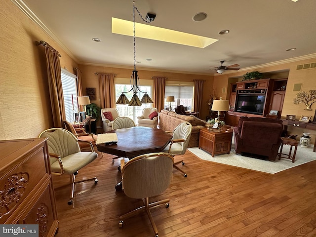 5054 Valley Stream Ln, Macungie, PA 18062 - dining area featuring plenty of natural light, wood finished floors, ornamental molding, a ceiling fan, and a skylight
