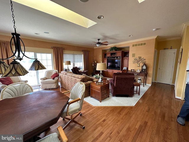 5054 Valley Stream Ln, Macungie, PA 18062 - living area featuring a skylight, light wood-style floors, crown molding, ceiling fan, and baseboards