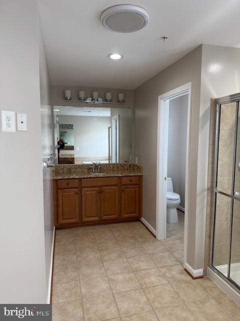 2307 Brooke Grove Rd, Bowie, MD 20721 - full bathroom with toilet, a stall shower, vanity, tile patterned floors, and baseboards