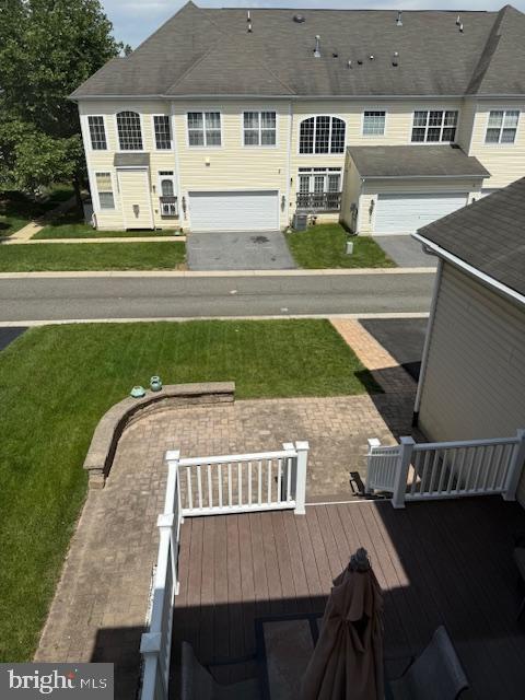 2307 Brooke Grove Rd, Bowie, MD 20721 - back of property featuring a yard, a deck, and an attached garage