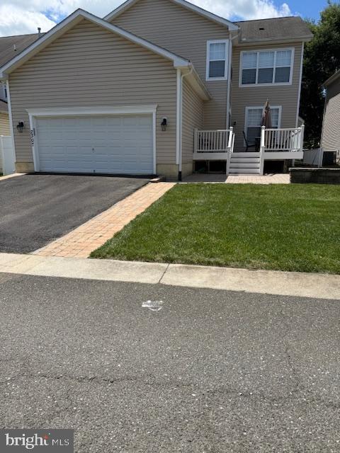 2307 Brooke Grove Rd, Bowie, MD 20721 - view of front of home with driveway, an attached garage, a front yard, and a wooden deck