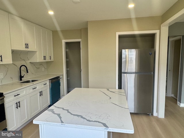 3627 Longridge Ct, Abingdon, MD 21009 - kitchen featuring freestanding refrigerator, dishwasher, a sink, white cabinetry, and light wood-style flooring