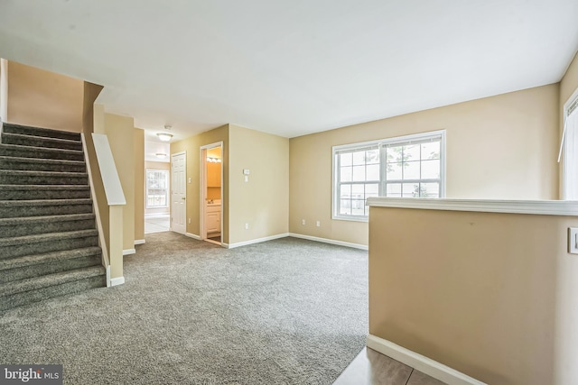216 Parker Ave, Philadelphia, PA 19128 - unfurnished living room featuring baseboards, stairs, and carpet