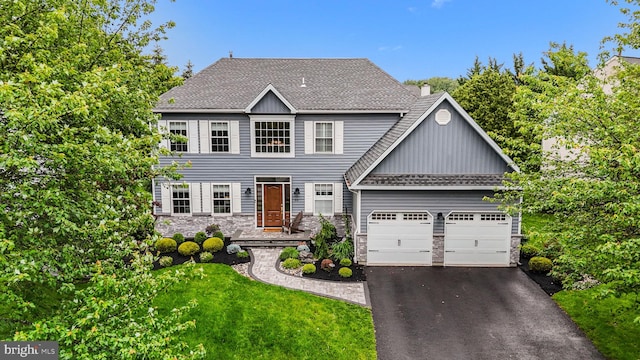 33 Jonquil Dr, Newtown, PA 18940 - colonial house featuring stone siding, board and batten siding, an attached garage, and asphalt driveway