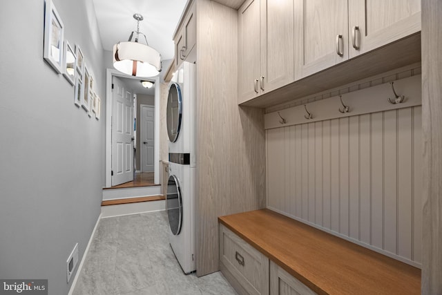 33 Jonquil Dr, Newtown, PA 18940 - washroom featuring stacked washer / drying machine, cabinet space, and baseboards