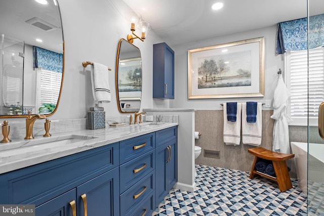 33 Jonquil Dr, Newtown, PA 18940 - bathroom featuring double vanity, a wainscoted wall, toilet, an enclosed shower, and recessed lighting
