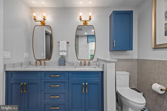 33 Jonquil Dr, Newtown, PA 18940 - bathroom with toilet, double vanity, wainscoting, and tile walls