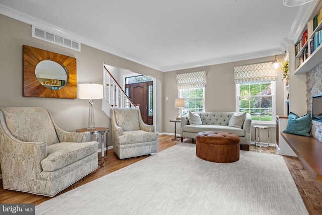 33 Jonquil Dr, Newtown, PA 18940 - living room featuring wood finished floors, crown molding, stairs, baseboards, and a fireplace