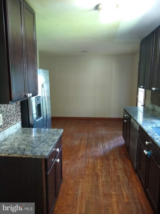 9438 Waterford Dr, Manassas, VA 20110 - kitchen with appliances with stainless steel finishes, decorative backsplash, light stone countertops, and dark wood finished floors