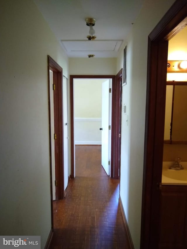 9438 Waterford Dr, Manassas, VA 20110 - corridor featuring a sink, dark wood-style floors, baseboards, and attic access