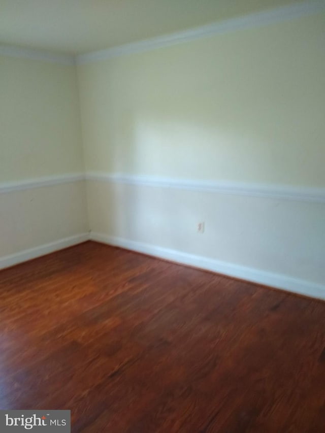 9438 Waterford Dr, Manassas, VA 20110 - empty room with dark wood-style flooring, crown molding, and baseboards